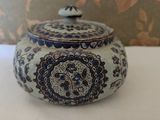 a blue and white teapot sitting on a table