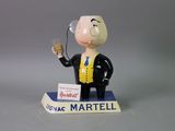 a figurine of a man holding a glass of wine