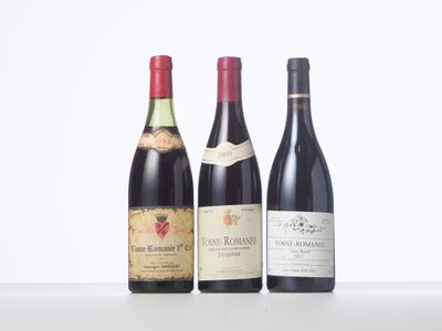 three bottles of wine are lined up on a table
