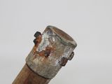 a close up of a wooden stick with a rusted handle