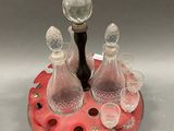 bottles and glasses on a tray with a wine stopper