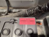 an image of a close up of a vehicle ' s engine with a sticker on it