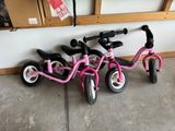 three bikes parked next to each other in a garage