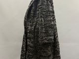 a black and white fur coat on a mannequin stand