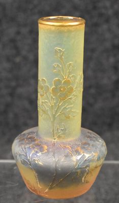 a glass vase that has a yellow and yellow design on it