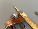 a violin that is sitting on a table with a hammer