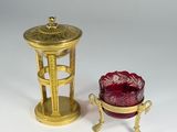 pair of gold and red glass candlesticks and a red glass candle holder