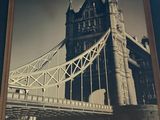 a picture of a picture of a bridge hanging on the wall