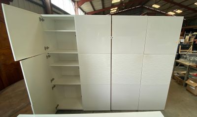 a large white cabinet in the middle of a room