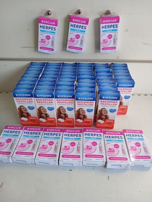 many boxes of toothpaste sitting on a table