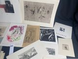 many different types of art work displayed on a table