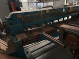 a machine that is working on a piece of wood