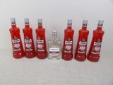 six bouteilles de vodka rouge alignées sur une table