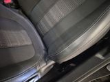 a close up of a car seat with a remote control