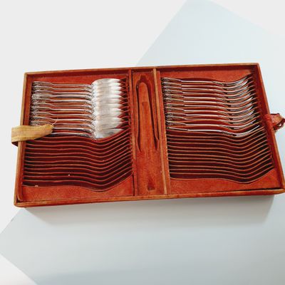 many forks and spoons in a wooden box on a table