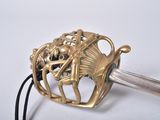 a gold sword with a gold handle and a black handle