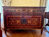 a wooden chest with a clock on it in a living room
