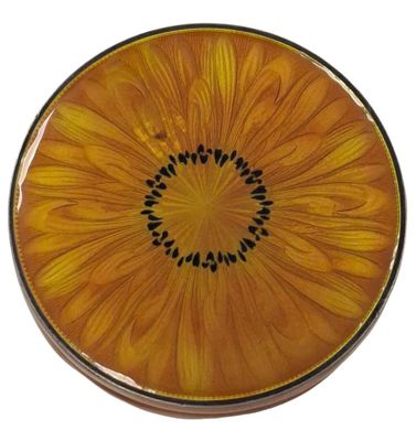 yellow and black plate with a flower on it on a white background