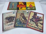 several children ' s books are lined up on a white surface