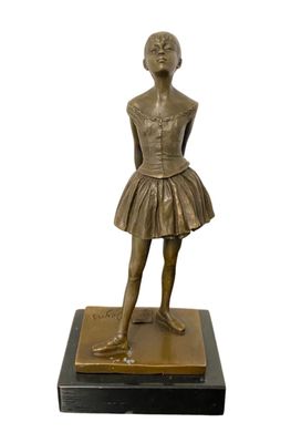 bronze statue of a young girl in a tutu skirt on a marble base