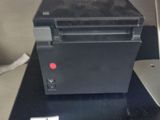 a black printer sitting on top of a desk next to a laptop