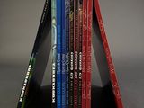books are stacked on top of each other on a gray surface