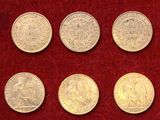 un gros plan sur un tas de pièces de monnaie posées sur une surface rouge