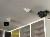 two cameras mounted on the ceiling of a kitchen