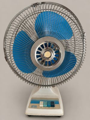 a white and blue fan sitting on top of a table