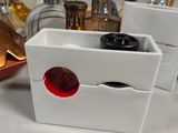 a white container with a red seal on top of it