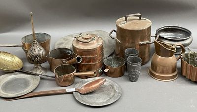 many different types of copper pots and pans on the table