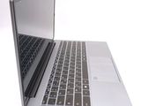 a silver laptop with a black keyboard on a white surface