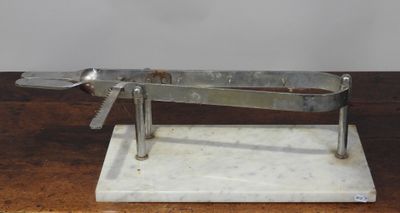 un objet en métal posé sur un socle en marbre, sur une table