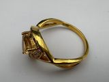 a close up of a gold ring with a diamond on it