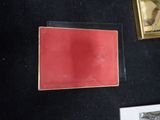 a picture of a picture of a red book on a black table