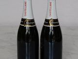 two bottles of champagne sitting on top of a marble counter top