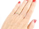 a woman ' s hand with a diamond ring on it