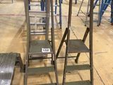 several ladders that are sitting on the floor in a warehouse