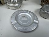 a silver plate sitting on top of a table next to other silverware