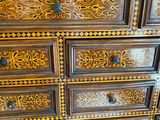a wooden chest of drawers with ornate designs on it