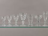 a glass shelf that has many wine glasses on it