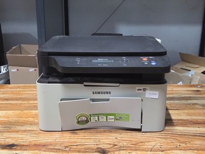a printer sitting on top of a box on a wooden table
