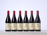 six bottles of red wine lined up in a row