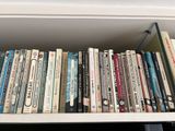 many books that are on a shelf in the room