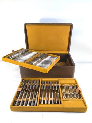 a brown box with silverware in it on a white surface