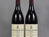 two bottles of wine sitting on top of a table next to each other