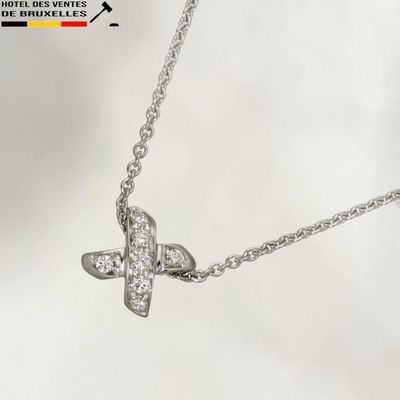 a silver necklace with a diamond butterfly on it