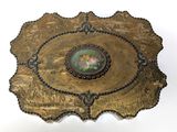 a gold plate with a picture of a flower on it