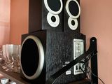 a shelf with speakers and wine glasses on top of it