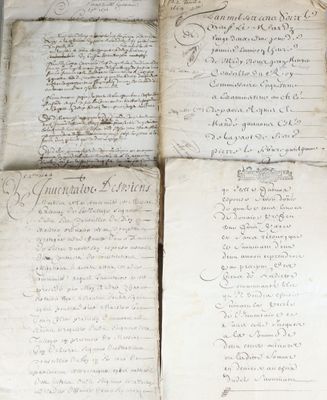 several old papers are stacked on top of each other on a table